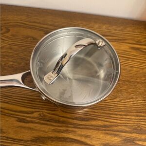 Princess House 18/10 Stainless Steel 1/2 Quart Saucepan with a glass lid.